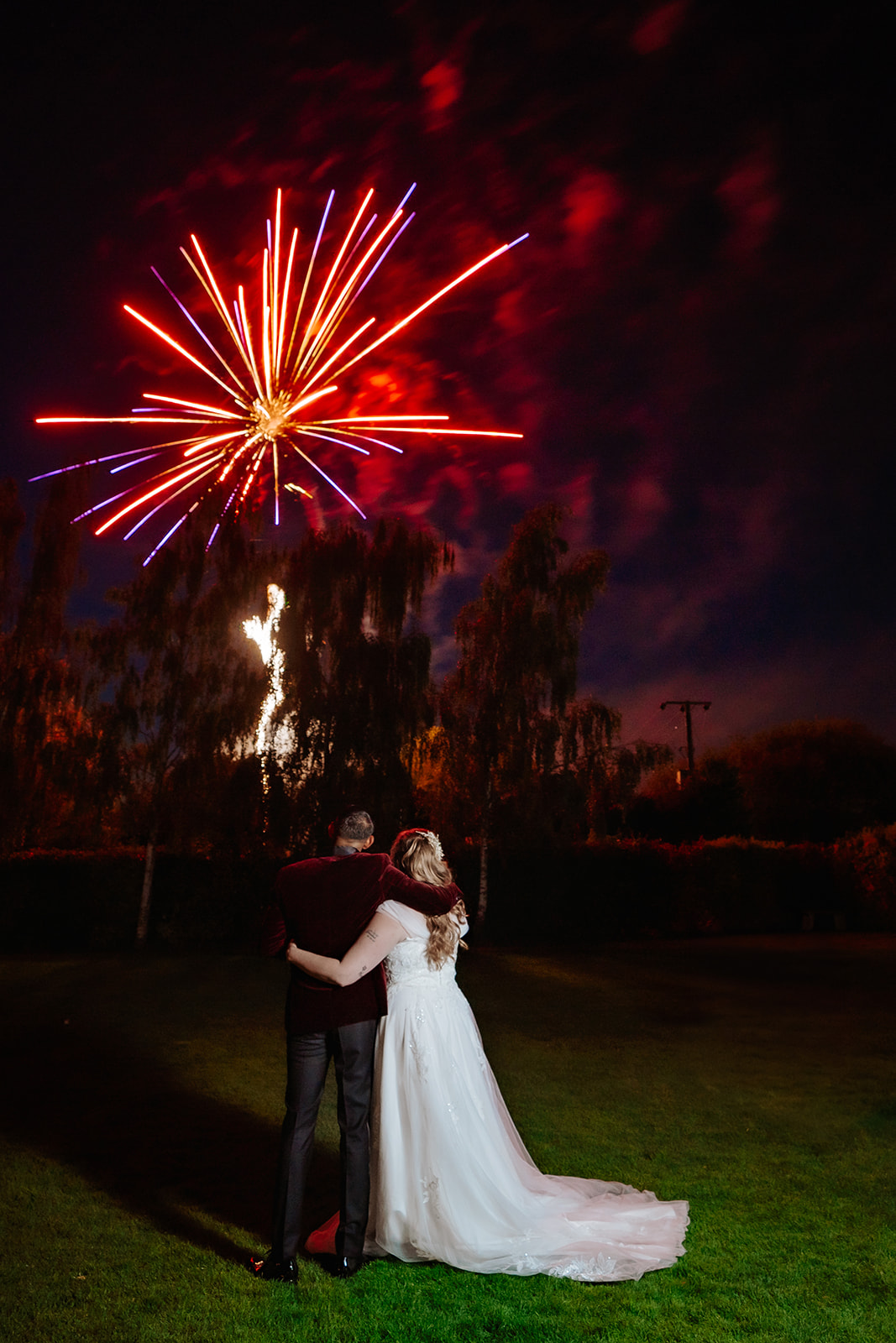 Bride and groom watching a fireworks display together at Crondon Park wedding venue in Essex — documentary wedding photography by Lily & White