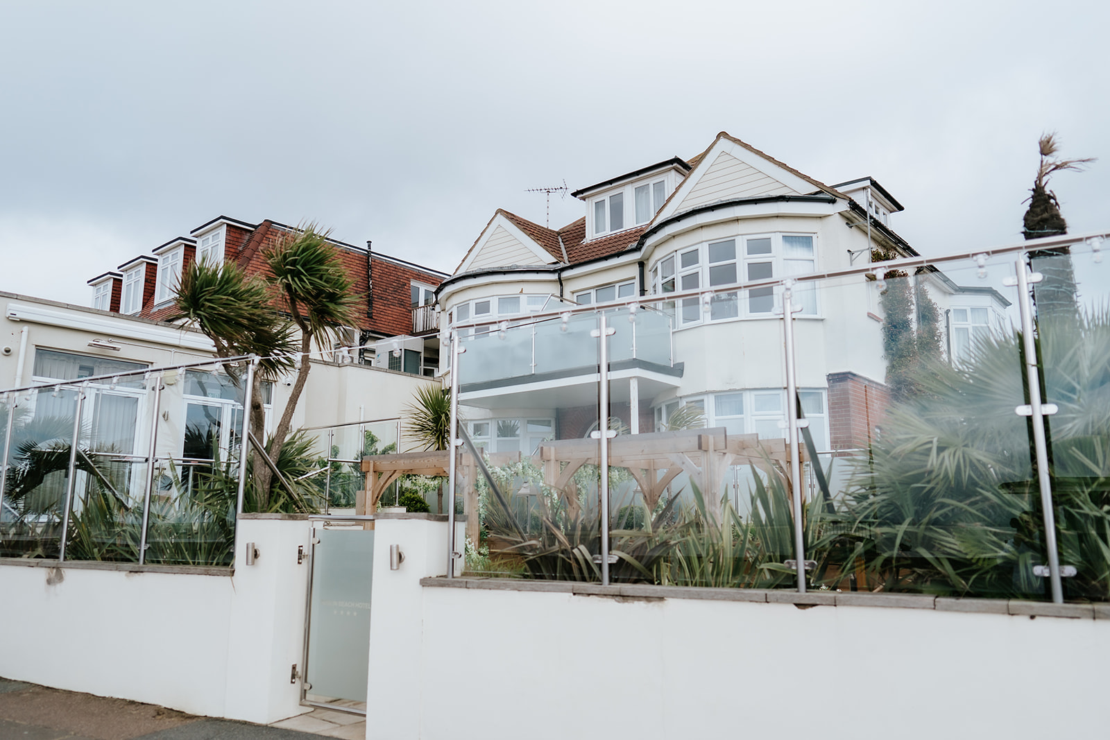 The exterior terrace and glass balconies of The Roslin Beach Hotel in Thorpe Bay, an Essex coastal wedding venue photographed by Lily & White