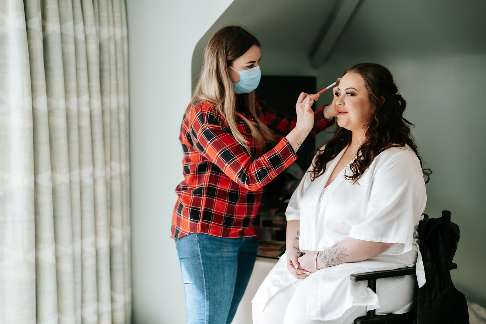 A bride having finishing touches done to her make-up before her southend-on-sea wedding at the Roslin hotel In Essex