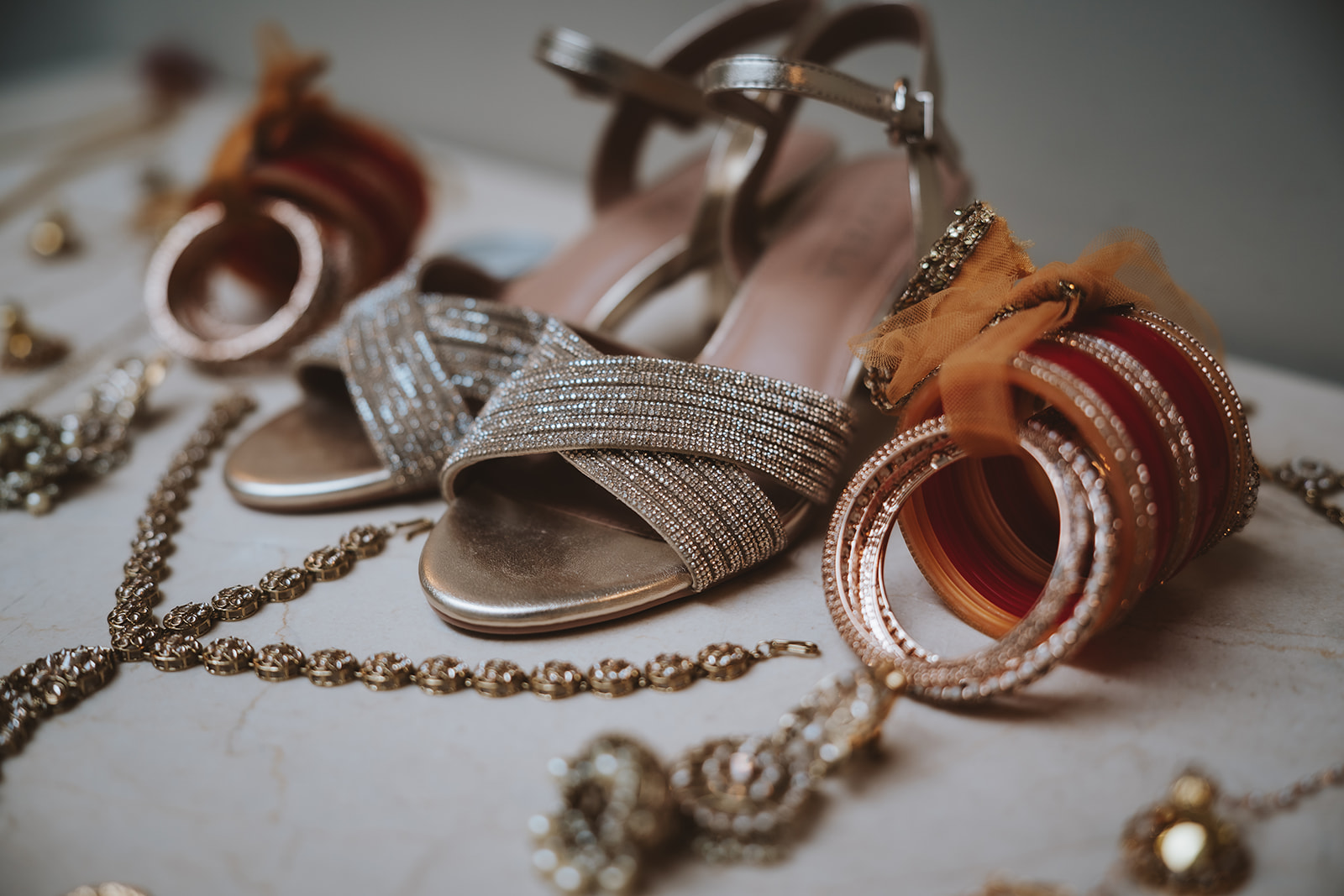 Hindu bridal details at Braxted Park - silver heels, gold bangles and pearl jewellery for Honica and Ben's fusion wedding