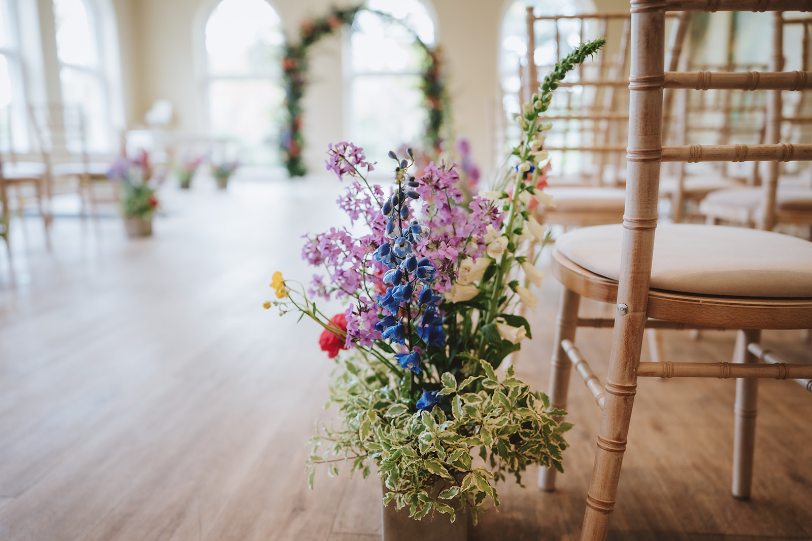 The Orangery at Braxted Park set for the civil ceremony - floral arch and natural light for Honica and Ben's fusion wedding Essex