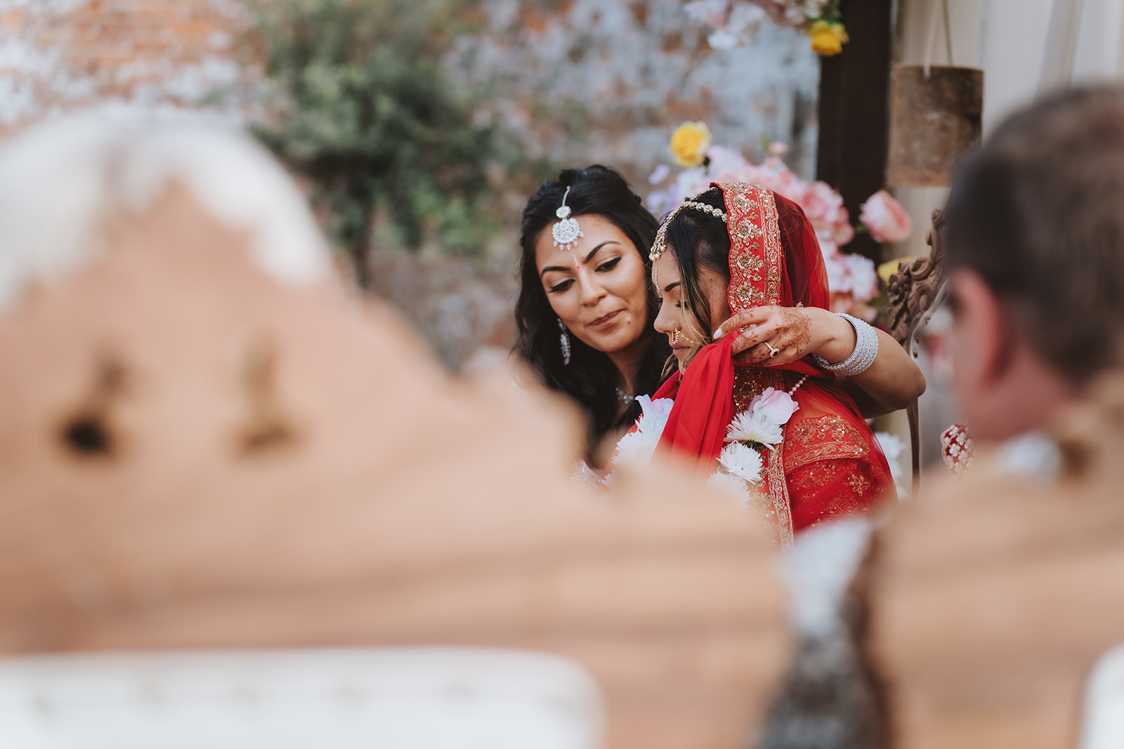 Emotional moment during the Hindu ceremony at Braxted Park - family embrace during Honica and Ben's fusion wedding Essex