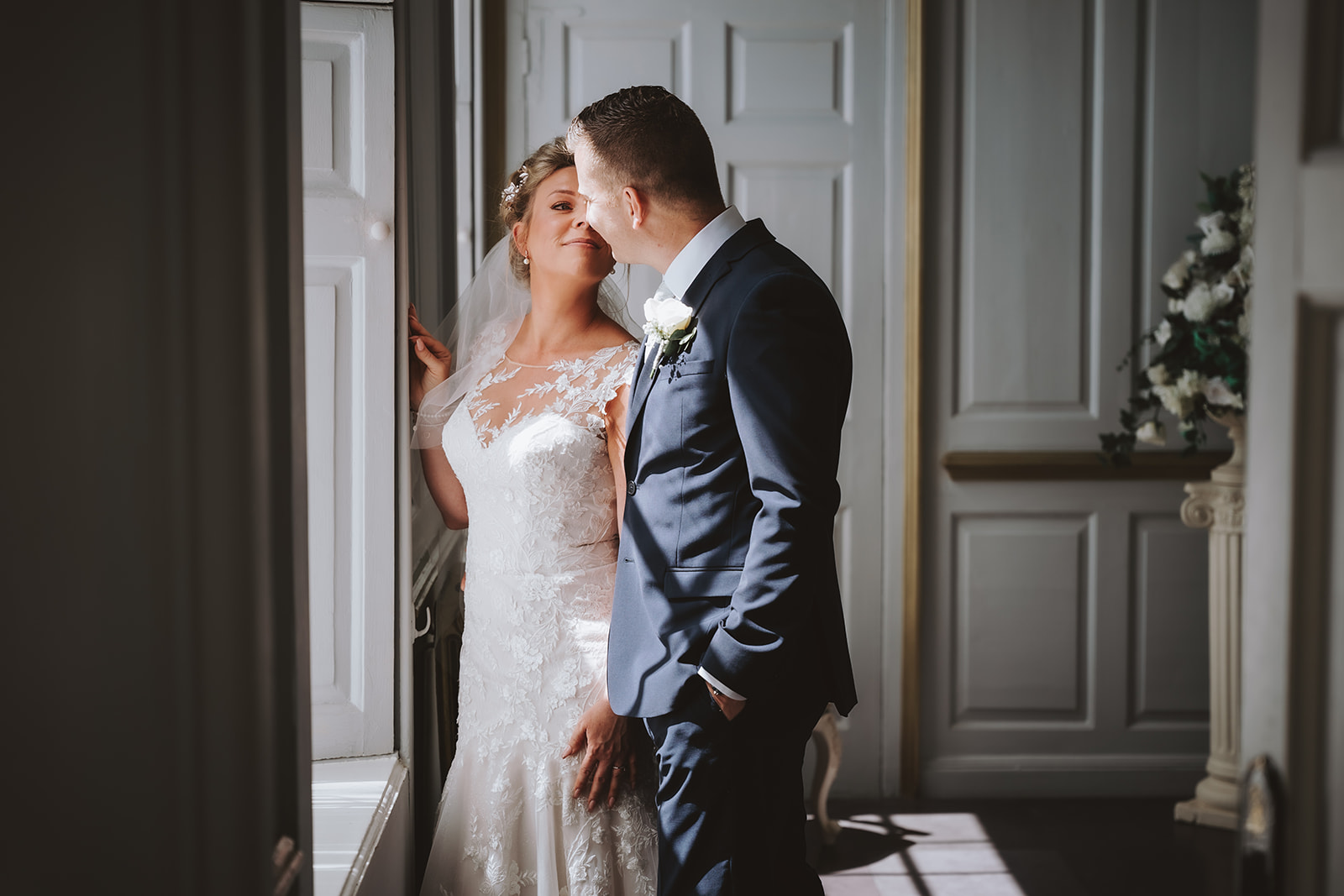 Bride and groom sharing a tender moment in the elegant Rococo Suite at Gosfield Hall wedding venue in Essex — documentary wedding photography by Lily & White
