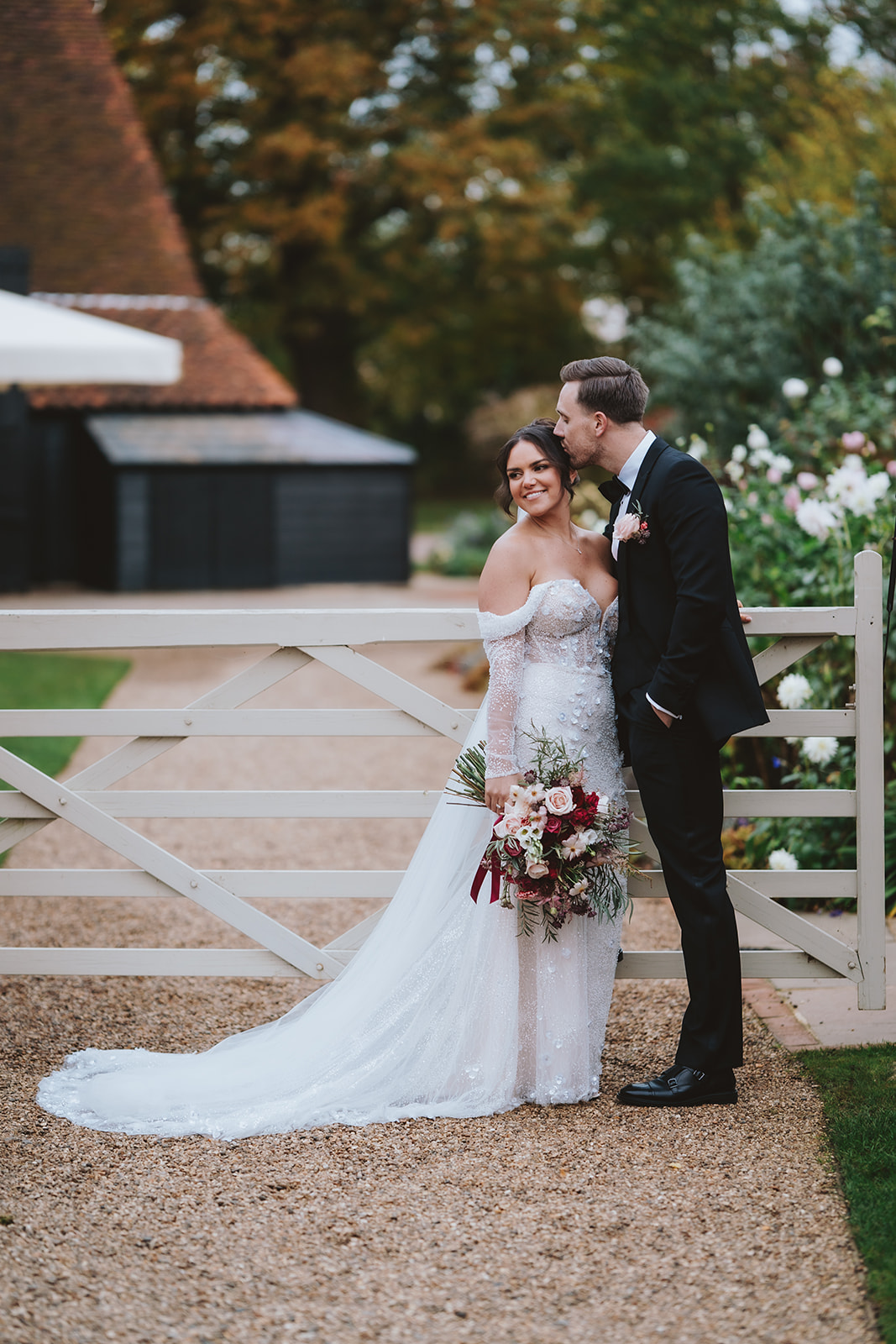 Abbey and Charlie by the white gate with the Essex Barn oast in the background.