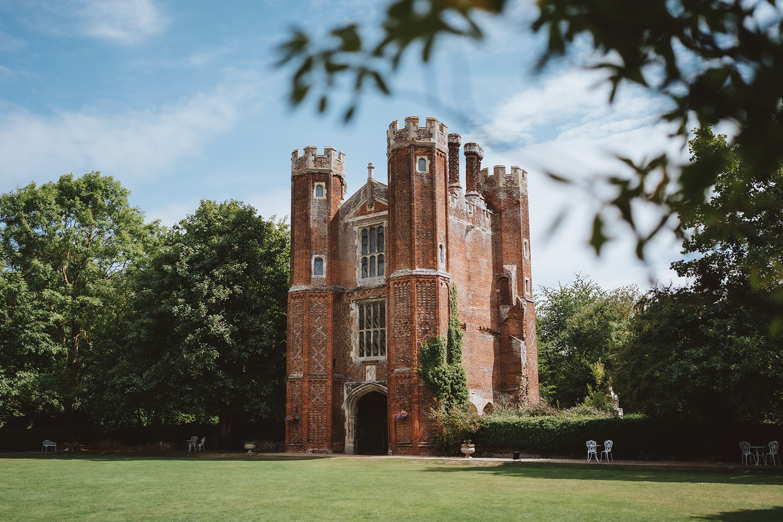 The historic Great Tower at Leez Priory wedding venue in Essex — a Tudor ceremony location with castellated towers and redbrick architecture — photographed by Lily & White