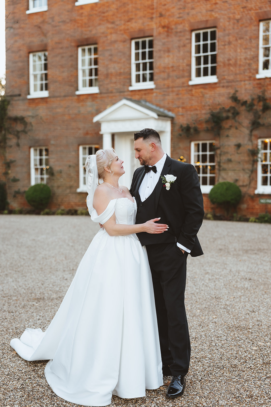 Bride and groom sharing a quiet moment in front of the Georgian facade of Mulberry House wedding venue in Essex — Lily & White wedding photography