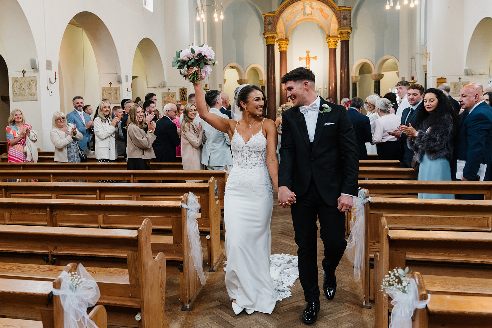A couple seated with family during their wedding ceremony