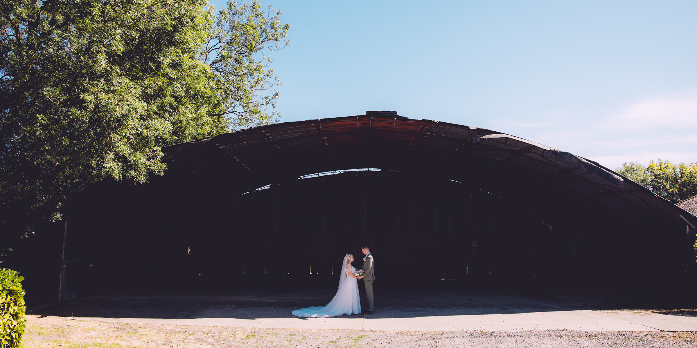 Bride and groom outside Clock Barn, Whitchurch, Hampshire