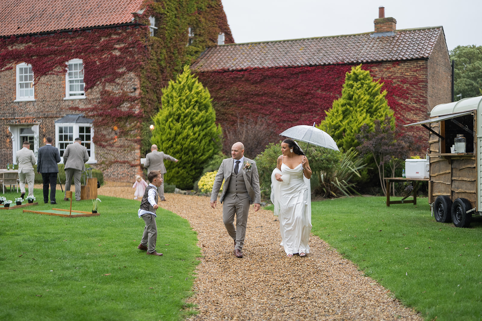 Sally and Callum walking in the grounds with Hornington Manor behind them